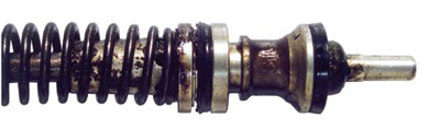 Harmful deposits and varnish build-up are apparent on this brake master cylinder piston